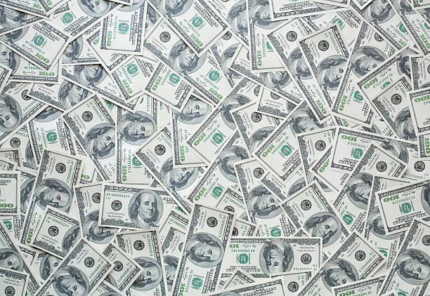 istock One hundred dollar bills background for your design 93180886