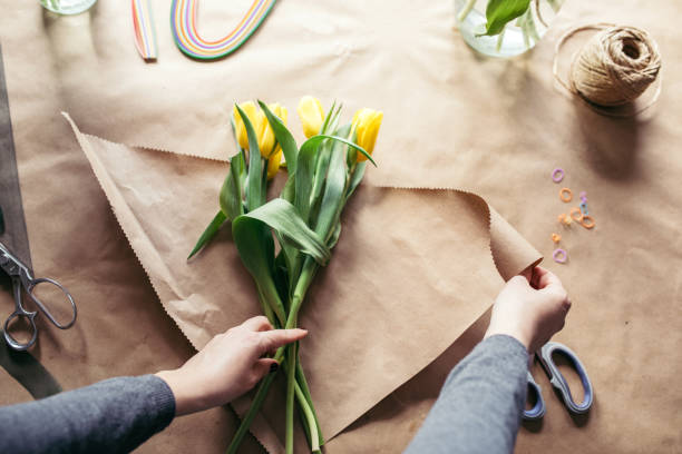 istock Young girl makes a tulip bouquet 931809158