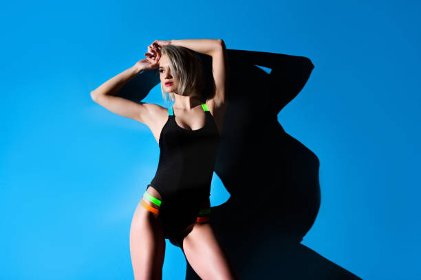 istock beautiful seductive girl posing in swimsuit, on blue 931809704