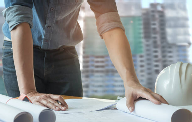 istock Architects have pencils in hand,writing home plan with condobackground. 931809736