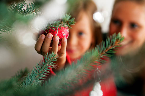 Family decorating Christmas tree stock photo