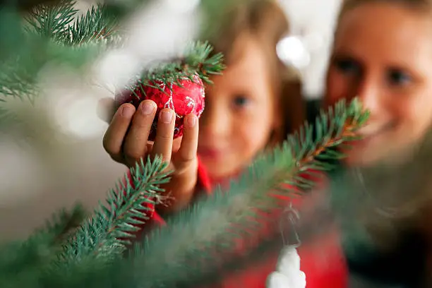 Photo of Family decorating Christmas tree