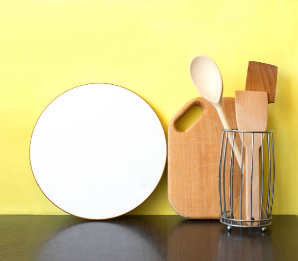 istock Kitchen utensils on the dark worktop over yellow background with copy space. Kitchen interior. 931815710