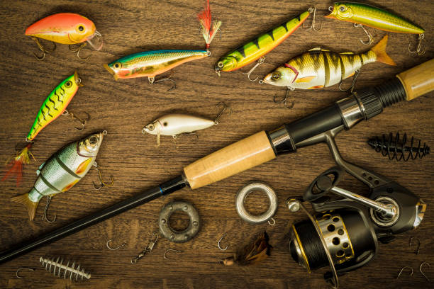 istock Fishing tackle on wooden background. 931816742