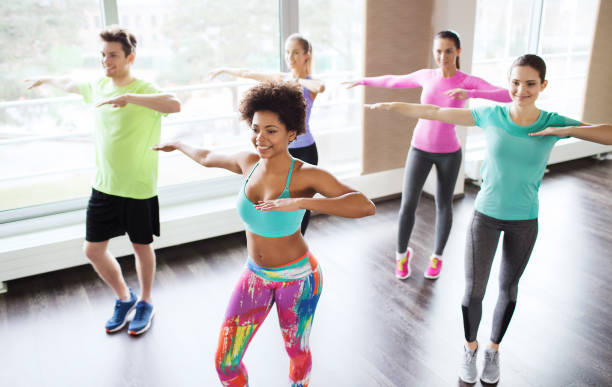 istock group of smiling people dancing in gym or studio 931817016