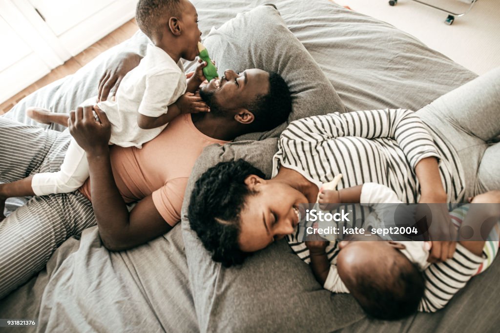 Connected parenting Happy family with  two kids Family Stock Photo