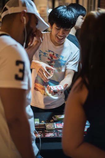 The Shopkeepers teach threir customer to play magic, Bangkok, Thailand 30 Sep 2017