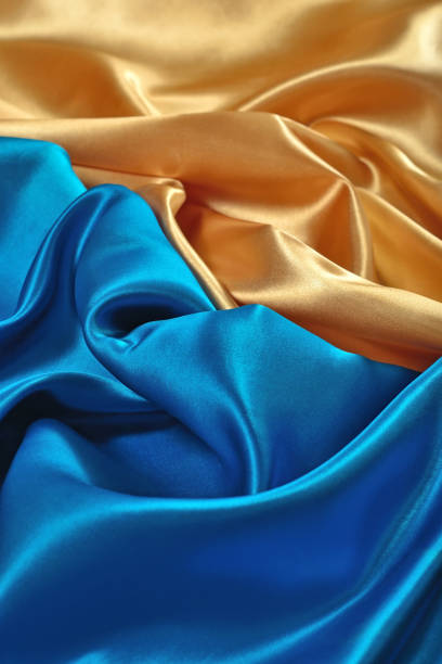 istock Natural golden and blue satin fabric texture 931824192