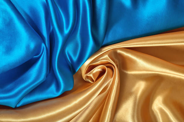 istock Natural golden and blue satin fabric texture 931824544
