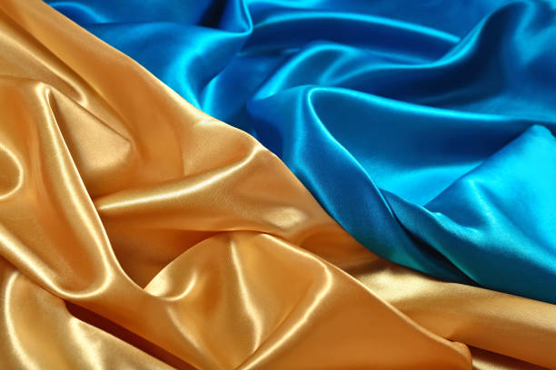 istock Natural golden and blue satin fabric texture 931825348
