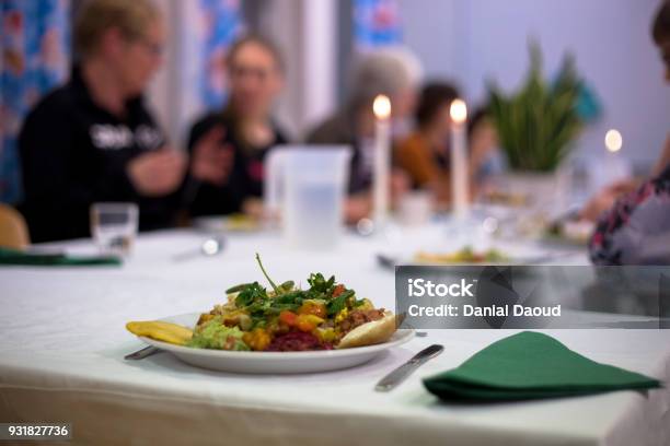 People Eating Vegan Food At A Cooking Class Stock Photo - Download Image Now - Table, Bean, Candle