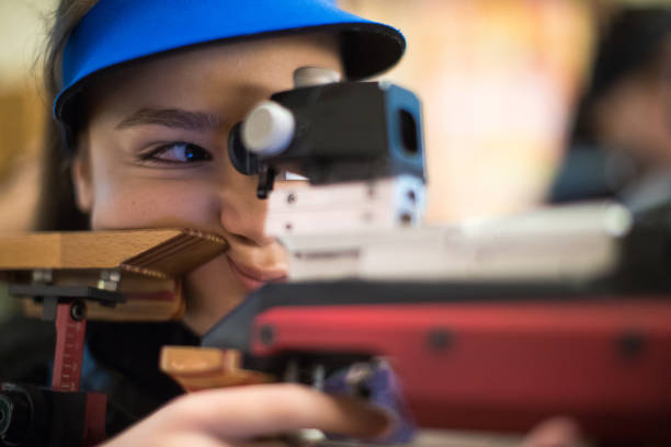 istock Woman with a gun ready to shoot on target 931827746