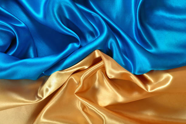 istock Natural golden and blue satin fabric texture 931829864