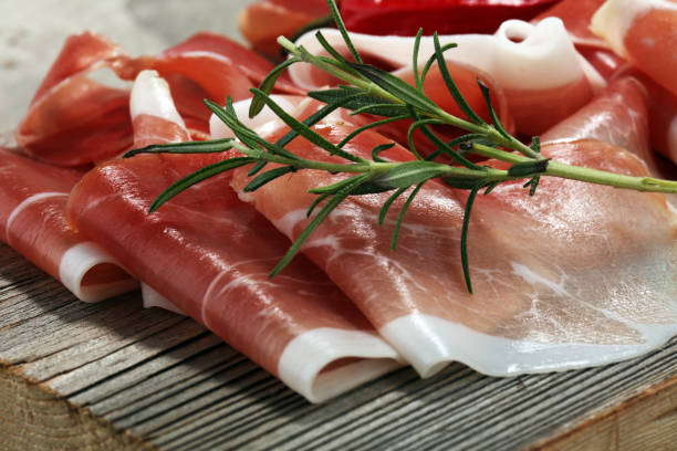 istock Italian prosciutto crudo or jamon with rosemary. Raw ham 931829996