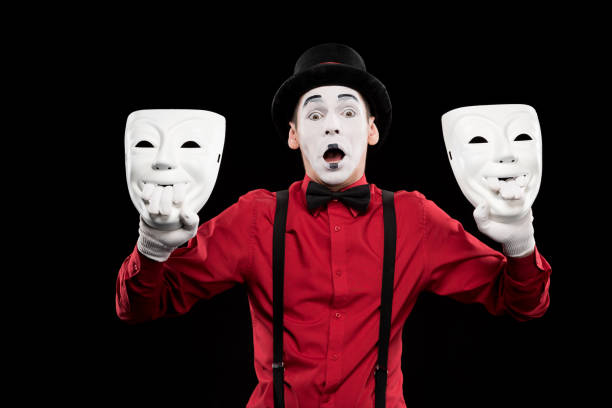 istock shocked mime holding two masks isolated on black 931830002