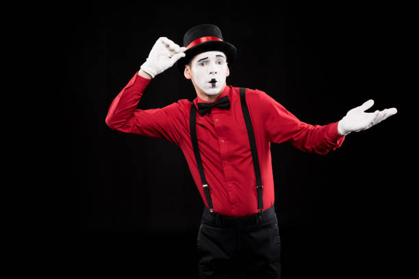 istock mime showing shrug gesture isolated on black 931831134