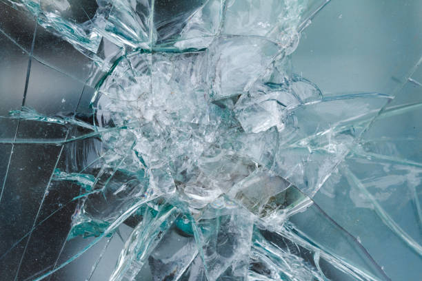 istock Firearms bullethole on bulletproof glass, cracks background 931831144