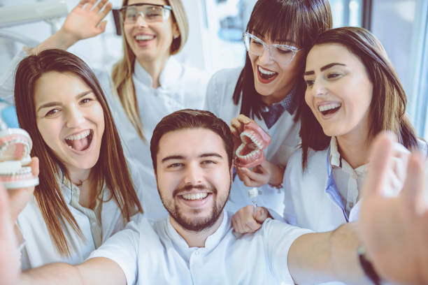 istock Group of Dentists Students Make Selfie with Dentures and Braces in Clinic 931831184