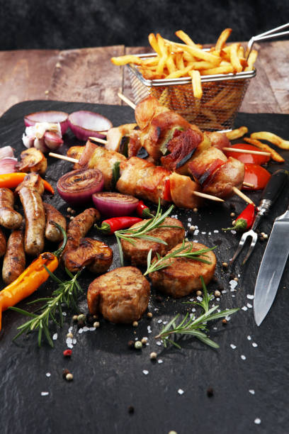 istock Assorted delicious grilled meat with vegetable and frites on a barbecue 931831520