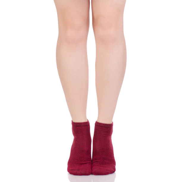 istock Female legs in red cotton socks 931835894