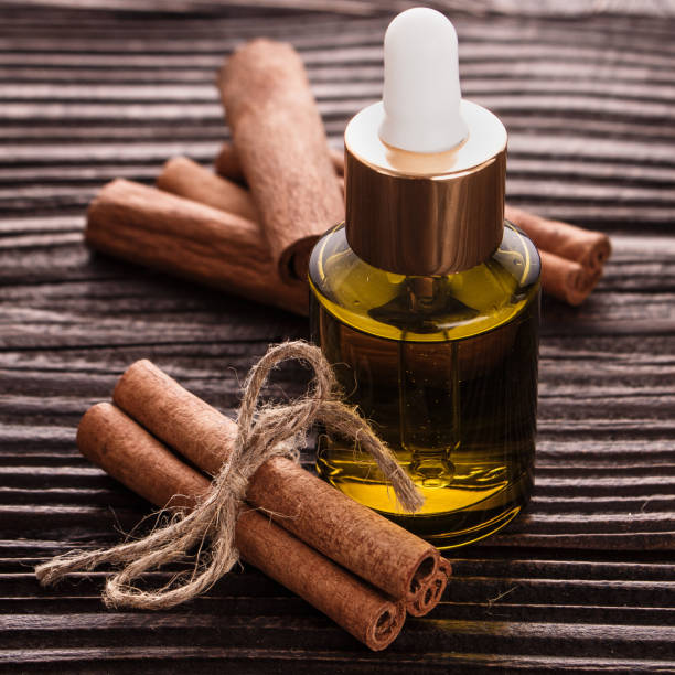 istock Cinnamon essential oil on a wooden background 931836400