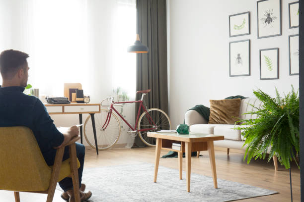 istock Man in yellow armchair 931836408