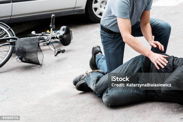 Pedestrian Helping Accident Victim Stock Photo - Download Image Now - Crash, Pedestrian, Car