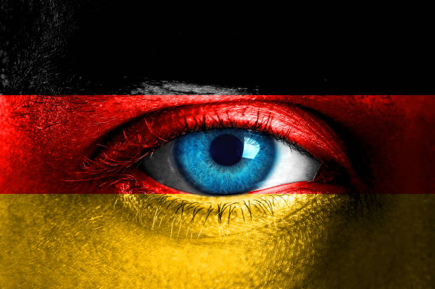istock Human face painted with flag of Germany 931840162