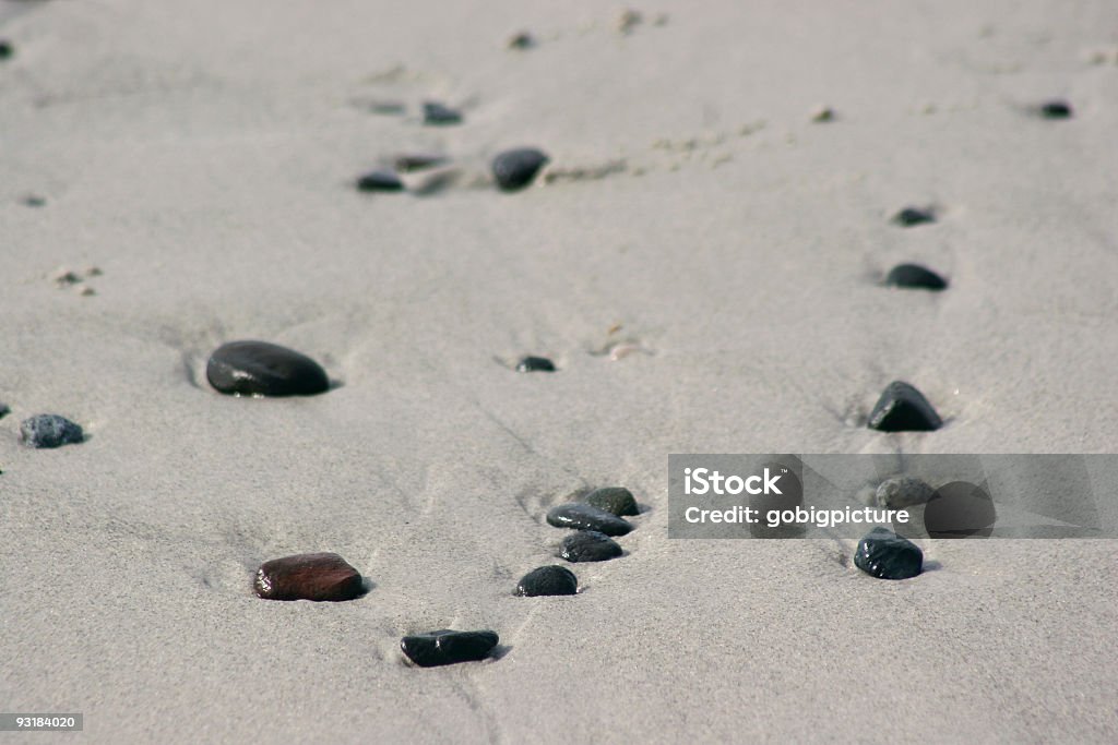 pebbles in the sand pebbles in the shoreline at pebble beach Abstract Stock Photo