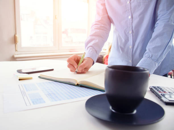 istock A businesswoman writes and drinks coffee 931840876