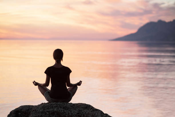 istock Woman is practicing yoga outdoors. Meditation and harmony concept 931843378