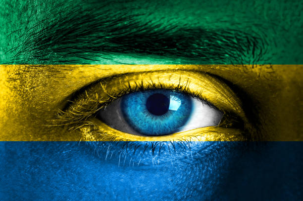 istock Human face painted with flag of Gabon 931844024