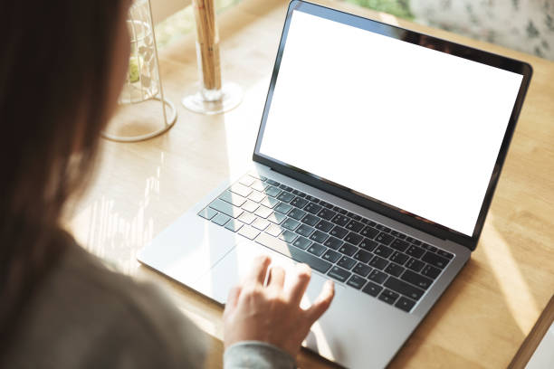 istock Women using laptop with blank screen at table in the office. 931845940