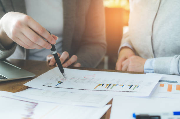 istock two attractive business woman teamwork working on table with strategy and analyze from document for decision in planning new project. 931853942