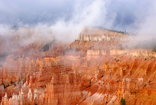 Bryce Canyons National Park - Sunrise Point Beautiful Sandstone Rock Formations in Bryce Canyon National Park. Foggy Morning Weather Burning Off At The Break Of Day.  Reds, Oranges, Blues and Whites. sunrise point stock pictures, royalty-free photos & images