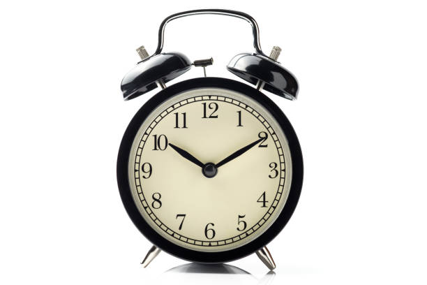 istock black vintage alarm clock isolated on white background with reflect on floor 931860248