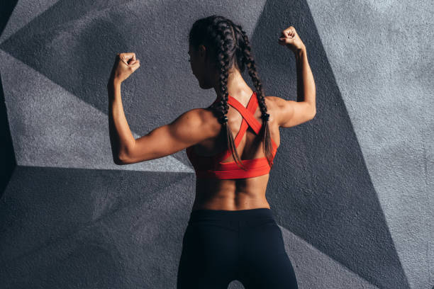 istock Fitness model posing showing muscles of the back and biceps. 931860868