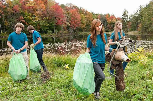 picking up trash at lakeside, green up day, high school students, autumn day