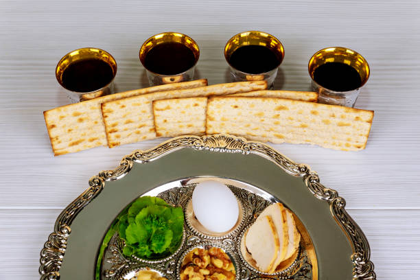 istock Pesah celebration Passover holiday. Traditional pesah plate text in hebrew: Passover, egg, 931884730