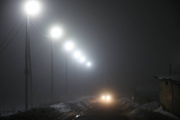 istock Lanterns along the night road in the fog 931894014
