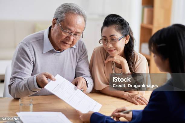 Studying Real Estate Purchase Agreement Stock Photo - Download Image Now - Planning, Senior Adult, Retirement