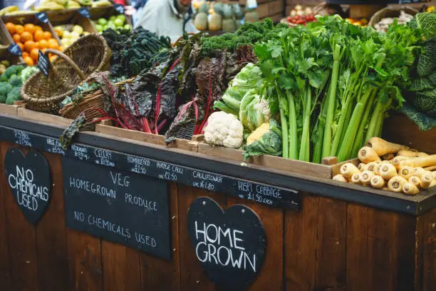 Vegetable stall in farmer market, including celery, parsnips and broccoli. Landscape format.