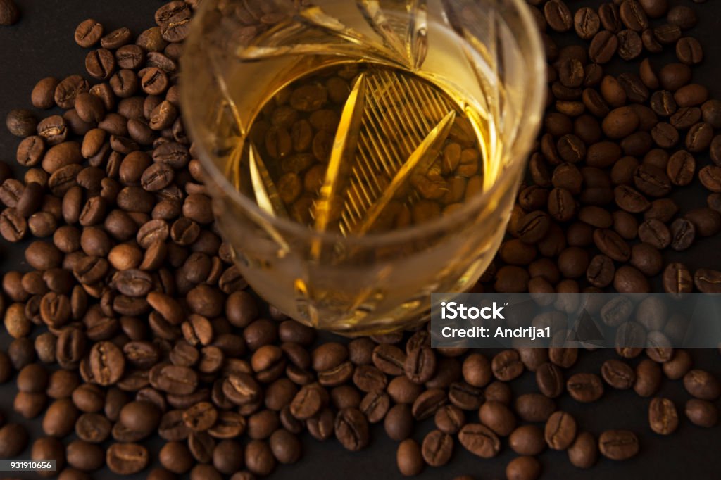 coffee beans and cognac in middle closeup coffee beans and cognac Alcohol - Drink Stock Photo