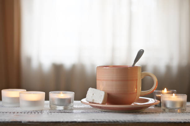 istock Cup of cocoa and burning candles 931913836