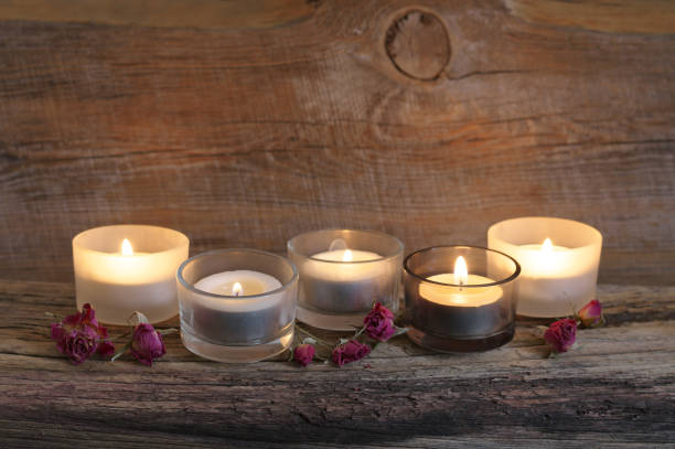 istock Burning candles on weathered wood 931914204