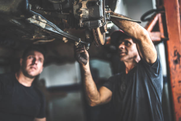 Professional mechanic repairing a car in auto repair shop Small Business auto mechanic photos stock pictures, royalty-free photos & images