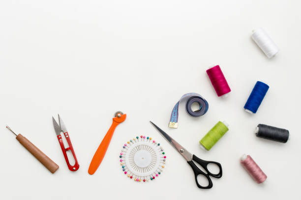 istock Tailor's work desk. Pattern of sewing accessories and tools on white background top view copyspace 931931010