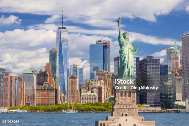 Statue Of Liberty And New York City Skyline With Manhattan Financial District World Trade Center Water Of New York Harbor Battery Park And Blue Sky Stock Photo - Download Image Now