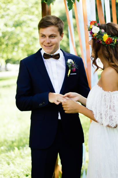 istock Bride put on wedding ring to groom's finger. 931934266
