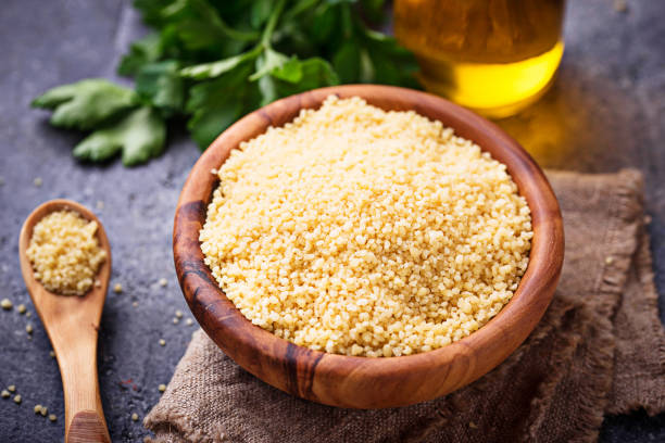 istock Couscous grain in wooden bowl 931934292